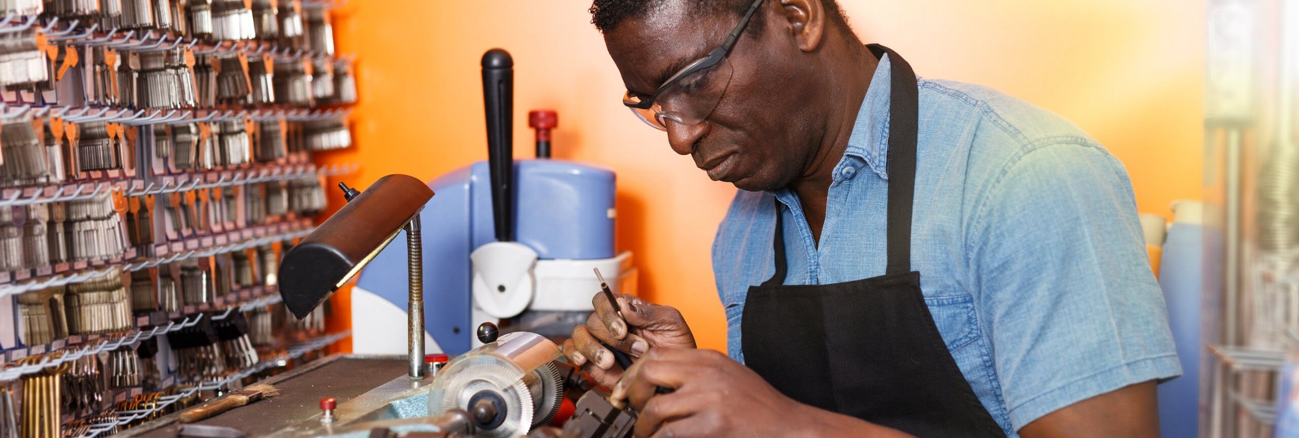 A man operates a machine in a factory, showcasing skill-based practices enhanced by Textkernel's skills intelligence APIs.